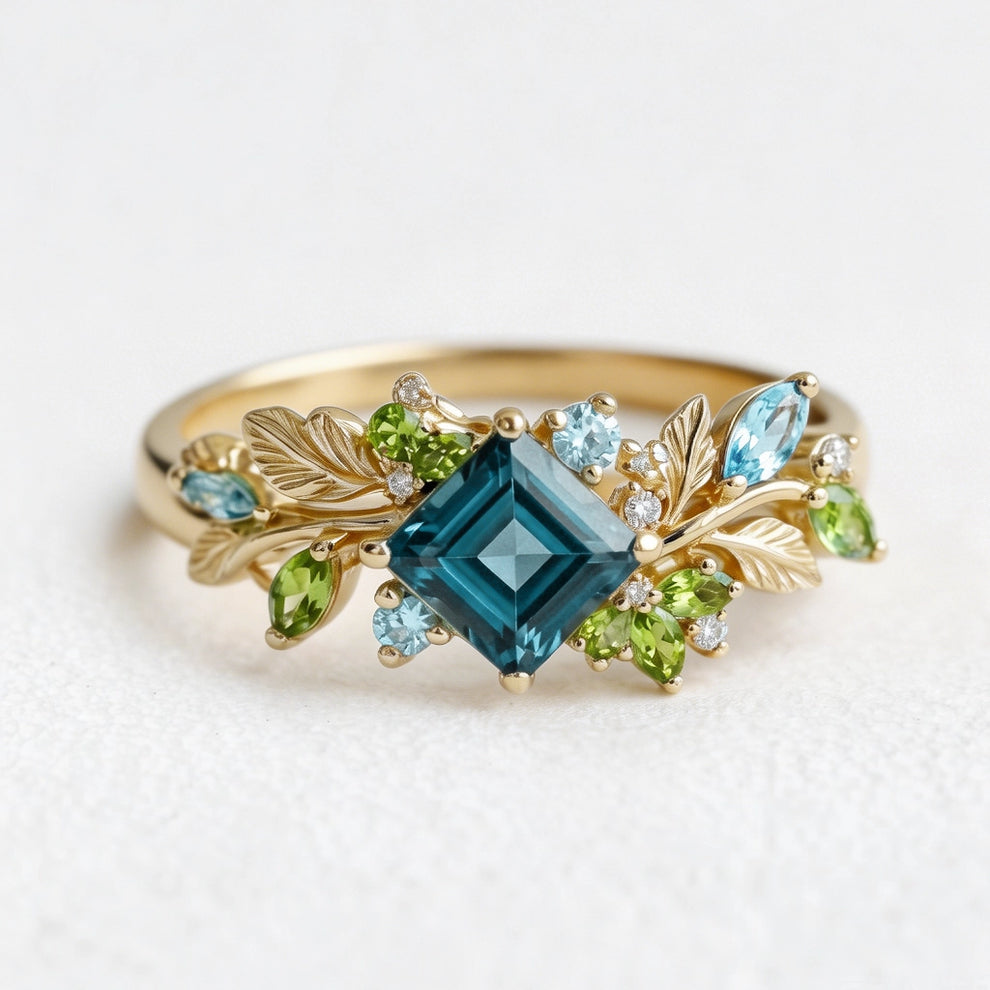 Elowen’s Gildedfrond | Princess Cut London Blue Topaz Leafy Engagement Ring.