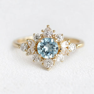 Marina's Blossom | Round Cut Aquamarine Engagement Ring With Pear Moissanite Petals.