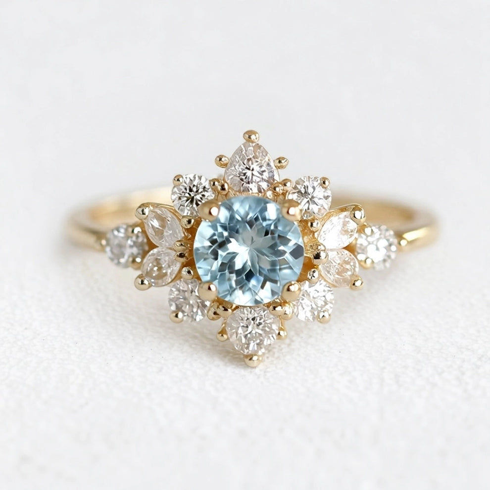 Marina's Blossom | Round Cut Aquamarine Engagement Ring With Pear Moissanite Petals.