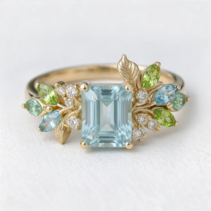 Calista’s Bloom | Emerald Cut Aquamarine Engagement Ring with Asymmetric Floral Accents.