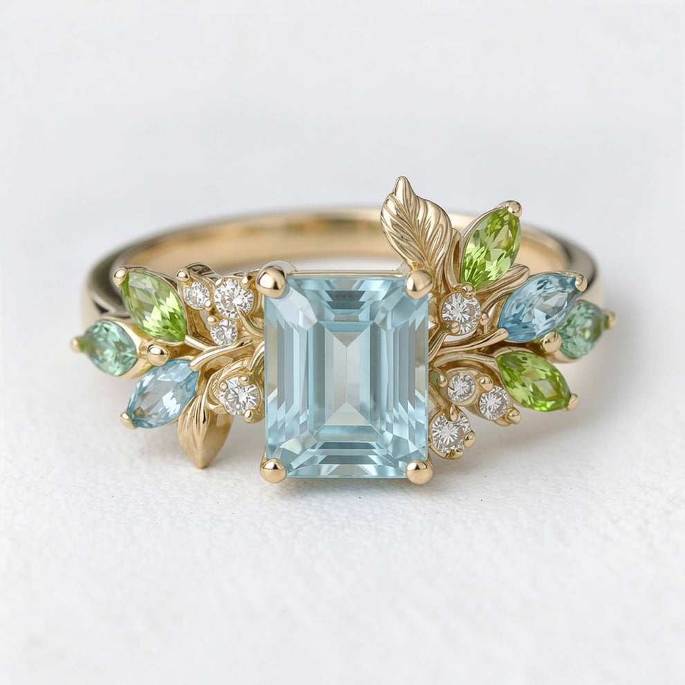 Calista’s Bloom | Emerald Cut Aquamarine Engagement Ring with Asymmetric Floral Accents.