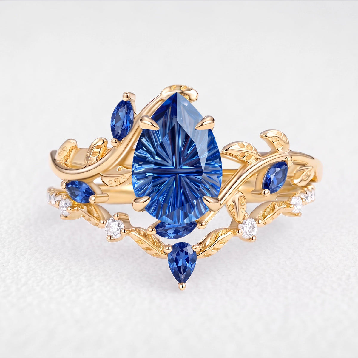 Titania’s Reverie | 1.5CT Fantasy-Cut Pear Blue Sapphire Foliage Bridal Duo