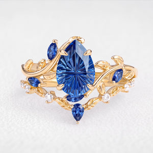 Titania’s Reverie | 1.5CT Fantasy-Cut Pear Blue Sapphire Foliage Bridal Duo