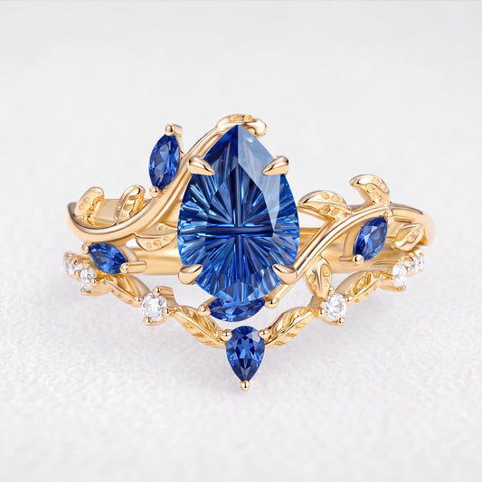 Titania’s Reverie | 1.5CT Fantasy-Cut Pear Blue Sapphire Foliage Bridal Duo