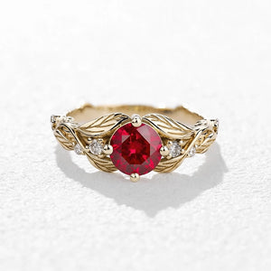 Rosalind’s Olive | Round Ruby Solitaire Ring with Olive Leaf Diamond Accents.
