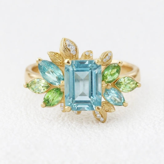 Flora’s Spring | Emerald Cut Blue Aquamarine Leaf Halo Engagement Ring.