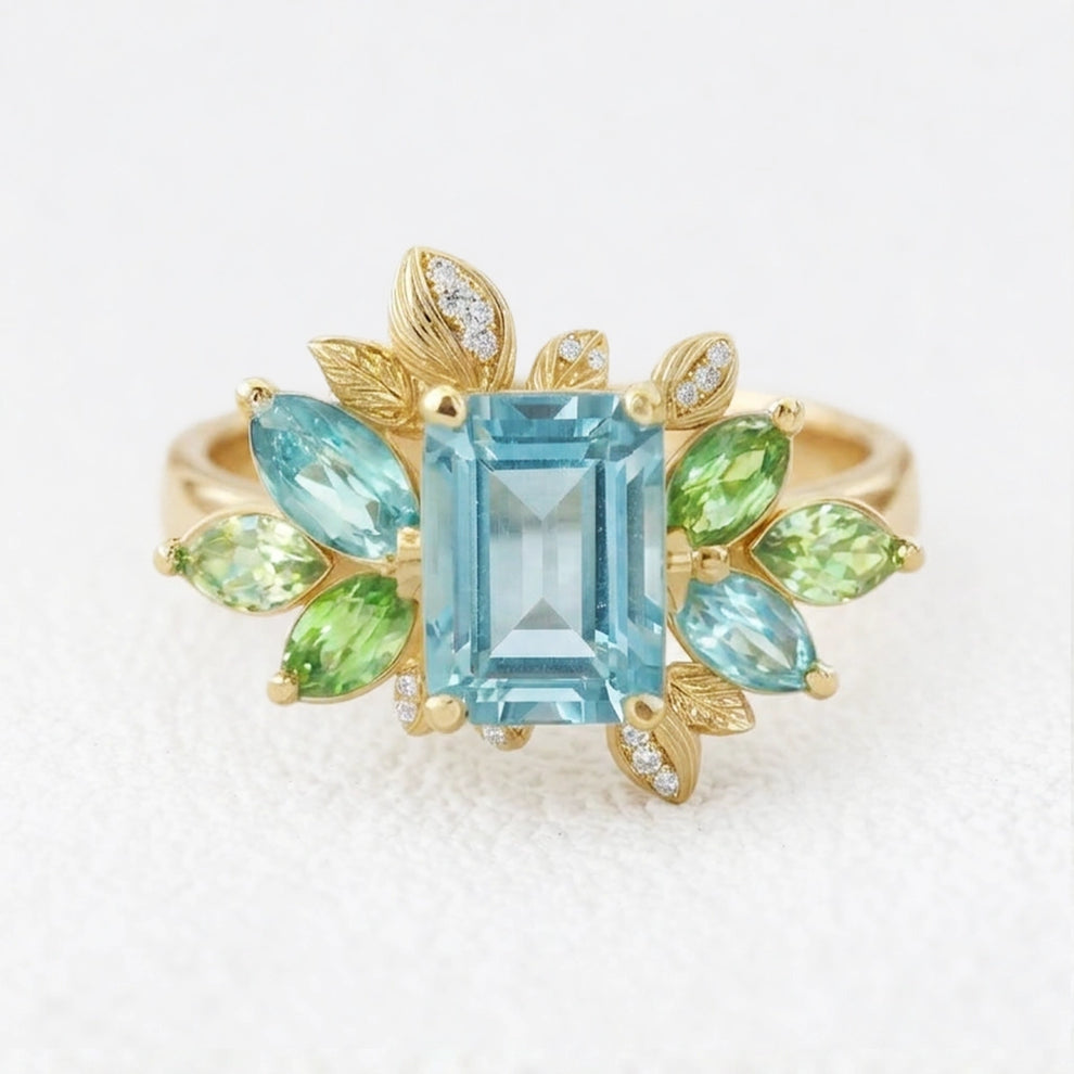 Flora’s Spring | Emerald Cut Blue Aquamarine Leaf Halo Engagement Ring.