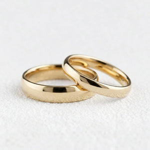 The Mirrored Pair – Polished Arc Wedding Bands in Solid Gold.
