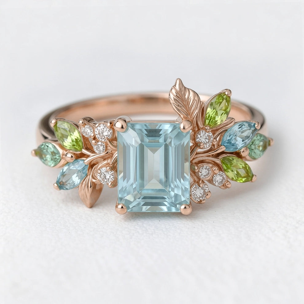 Calista’s Bloom | Emerald Cut Aquamarine Engagement Ring with Asymmetric Floral Accents.