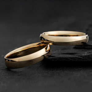 The Mirrored Pair – Polished Arc Wedding Bands in Solid Gold.