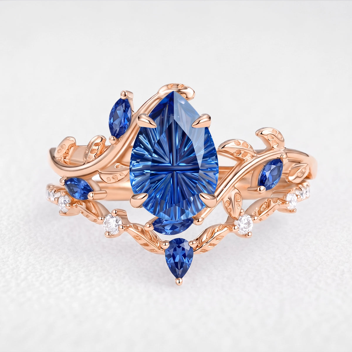 Titania’s Reverie | 1.5CT Fantasy-Cut Pear Blue Sapphire Foliage Bridal Duo