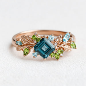 Elowen’s Gildedfrond | Princess Cut London Blue Topaz Leafy Engagement Ring.
