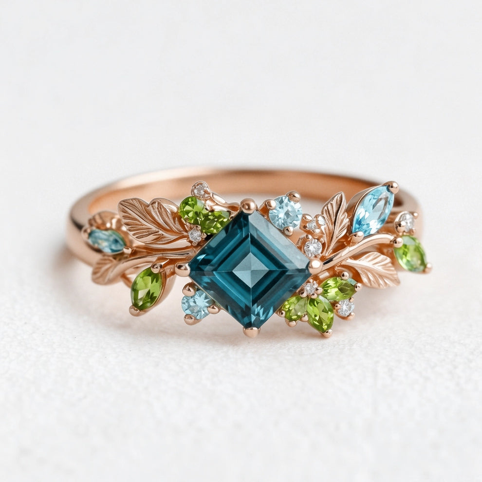 Elowen’s Gildedfrond | Princess Cut London Blue Topaz Leafy Engagement Ring.