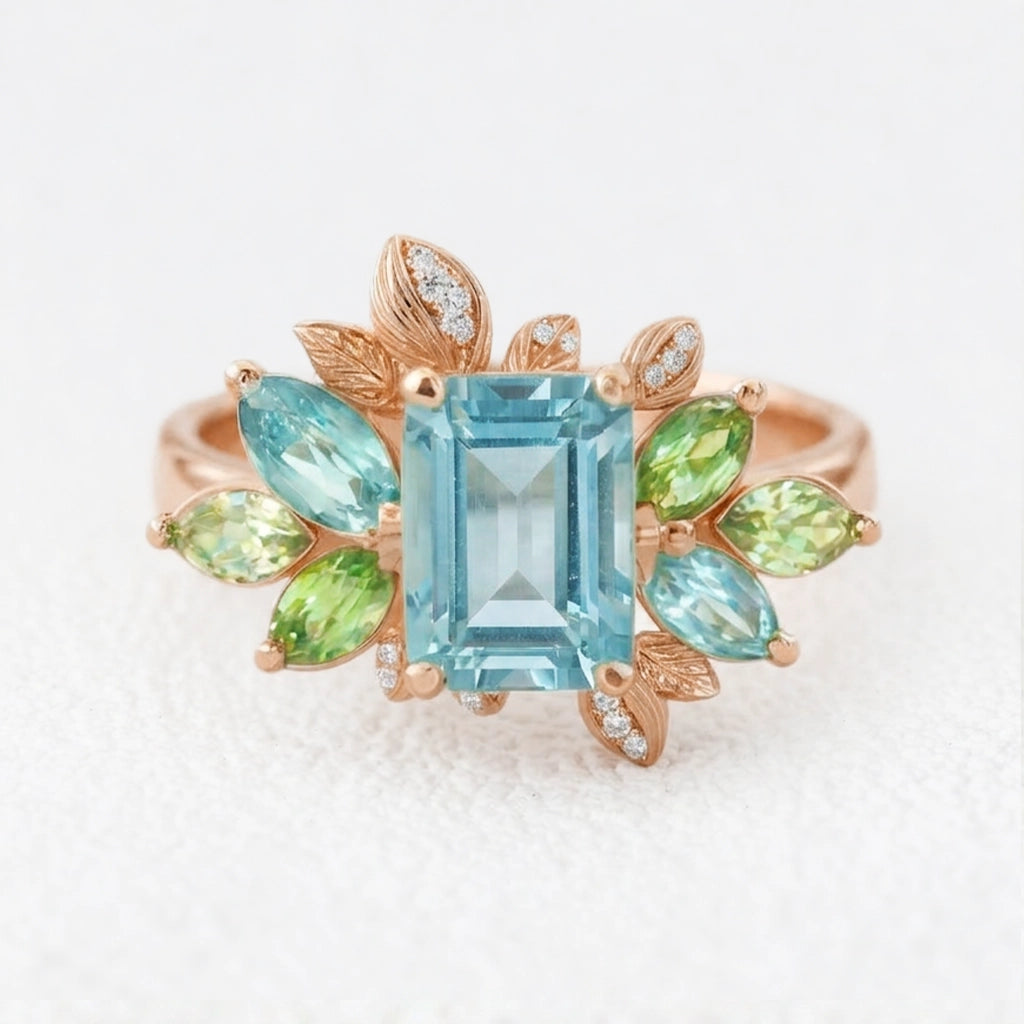 Flora’s Spring | Emerald Cut Blue Aquamarine Leaf Halo Engagement Ring.