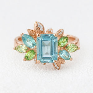 Flora’s Spring | Emerald Cut Blue Aquamarine Leaf Halo Engagement Ring.