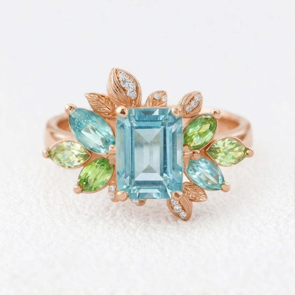 Flora’s Spring | Emerald Cut Blue Aquamarine Leaf Halo Engagement Ring.