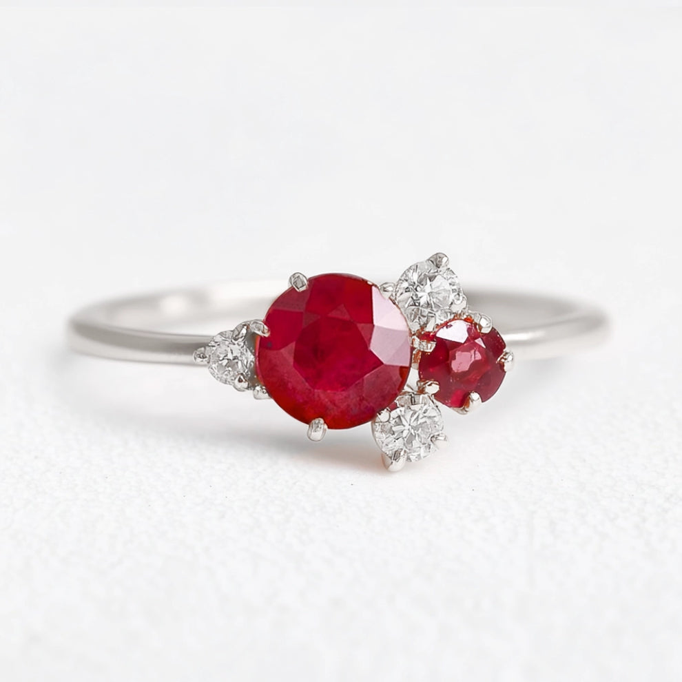 Rosalind’s Rose | Round Ruby Engagement Ring with Drifting Diamond Petal Halo.