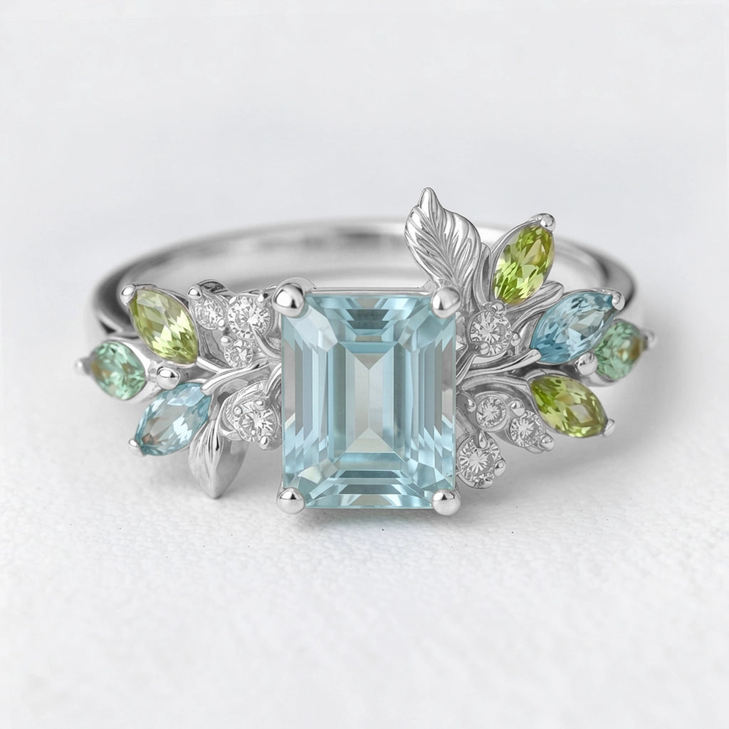 Calista’s Bloom | Emerald Cut Aquamarine Engagement Ring with Asymmetric Floral Accents.