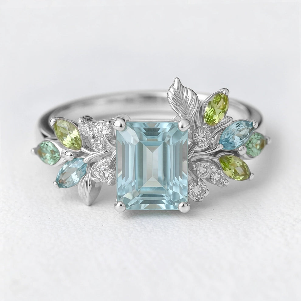 Calista’s Bloom | Emerald Cut Aquamarine Engagement Ring with Asymmetric Floral Accents.