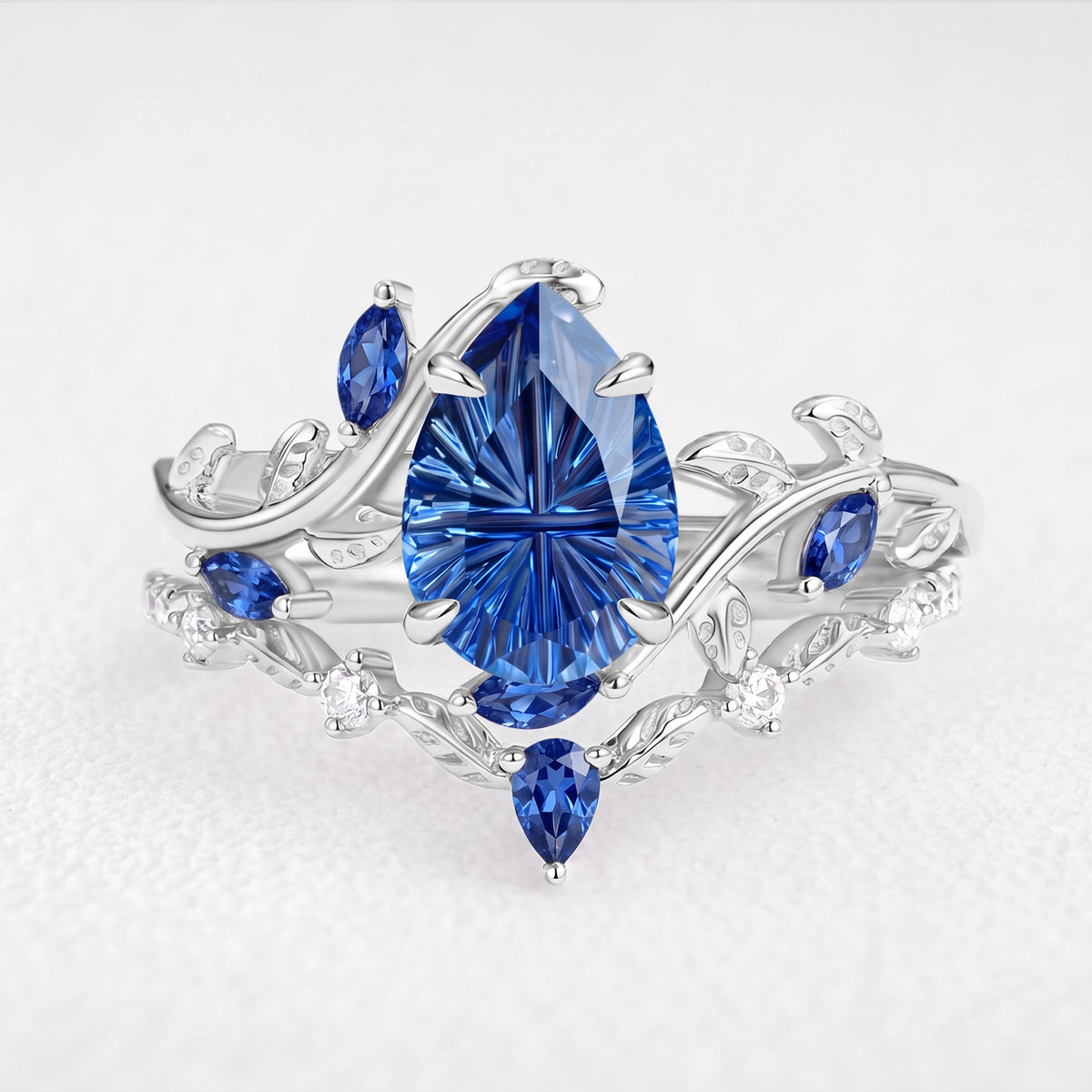 Titania’s Reverie | 1.5CT Fantasy-Cut Pear Blue Sapphire Foliage Bridal Duo