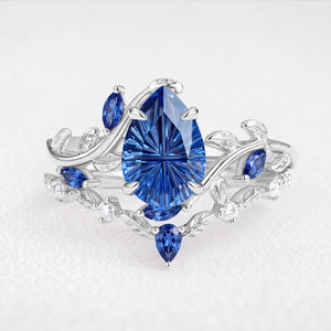 Titania’s Reverie | 1.5CT Fantasy-Cut Pear Blue Sapphire Foliage Bridal Duo