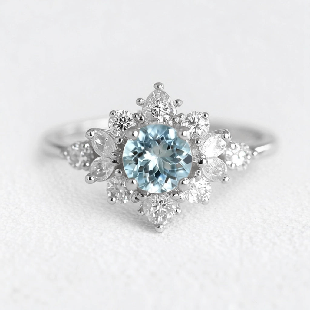 Marina's Blossom | Round Cut Aquamarine Engagement Ring With Pear Moissanite Petals.