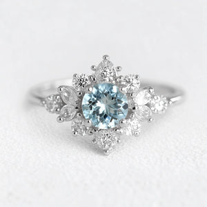 Marina's Blossom | Round Cut Aquamarine Engagement Ring With Pear Moissanite Petals.