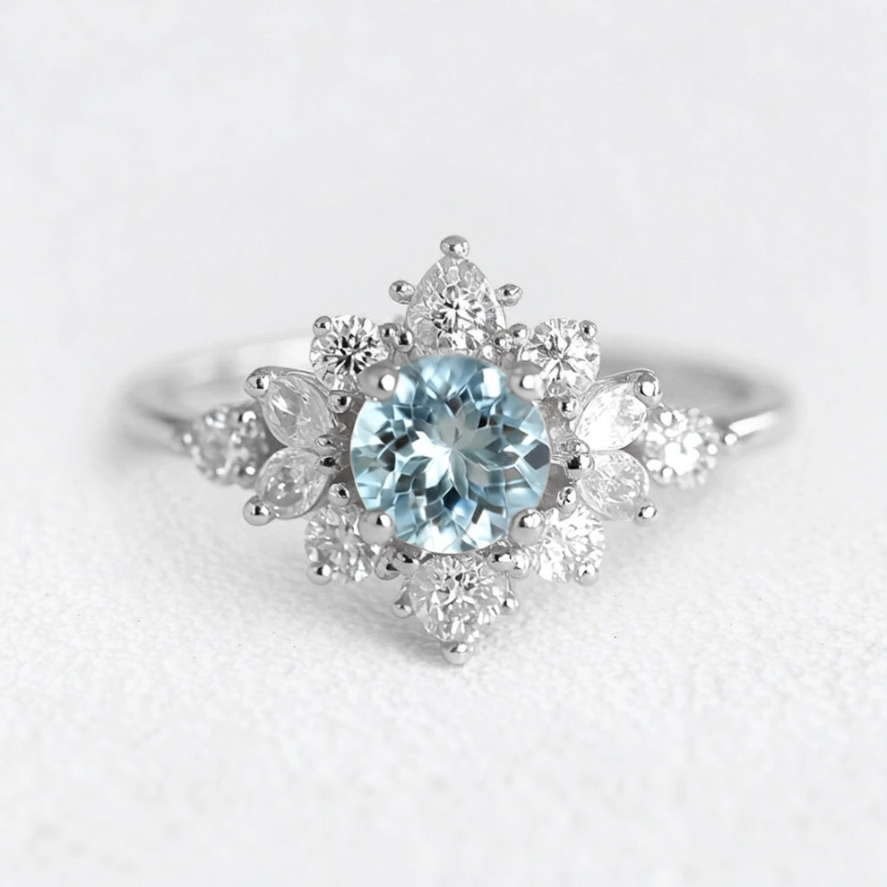 Marina's Blossom | Round Cut Aquamarine Engagement Ring With Pear Moissanite Petals.