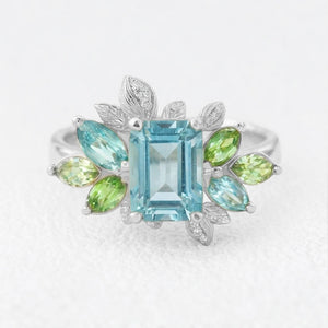 Celeste’s Bloom | Emerald Cut Blue Topaz Leafy Engagement Ring.
