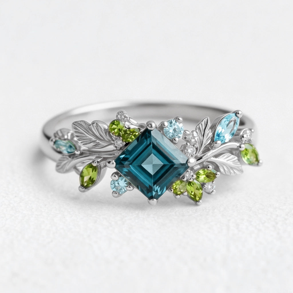 Elowen’s Gildedfrond | Princess Cut London Blue Topaz Leafy Engagement Ring.