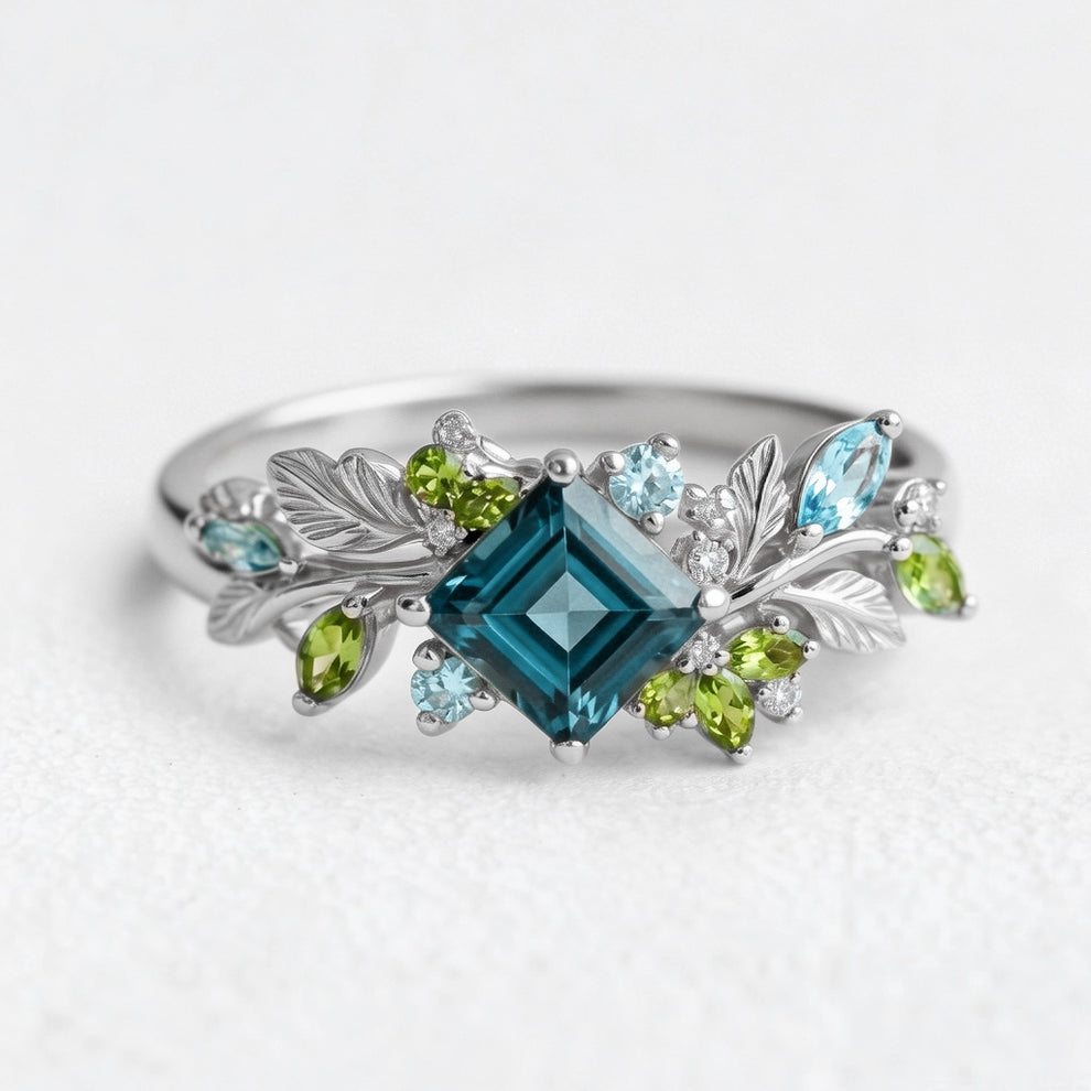Elowen’s Gildedfrond | Princess Cut London Blue Topaz Leafy Engagement Ring.