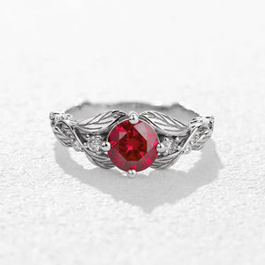 Rosalind’s Olive | Round Ruby Solitaire Ring with Olive Leaf Diamond Accents.