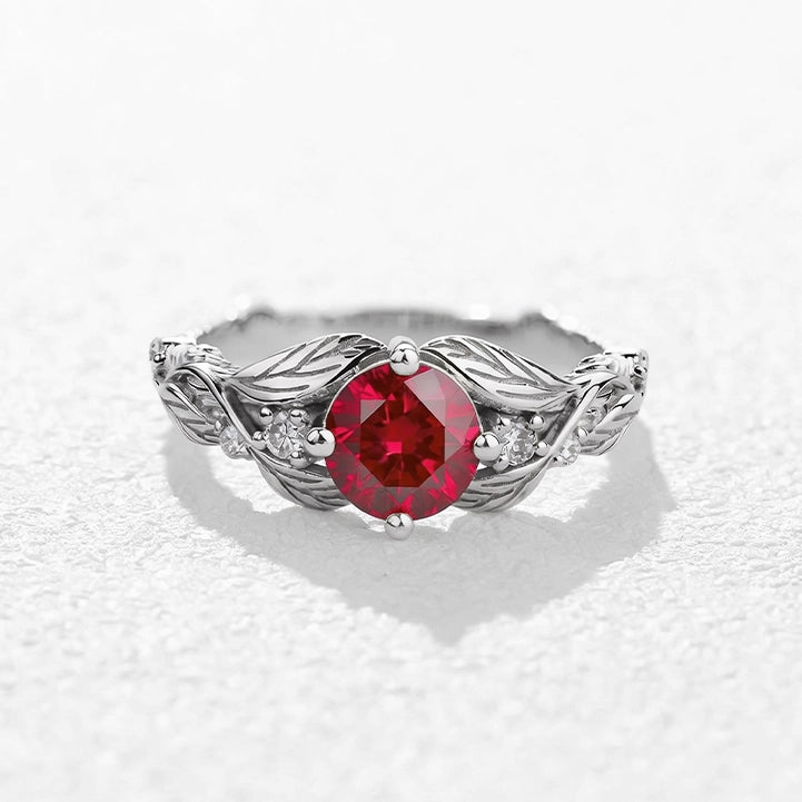 Rosalind’s Olive | Round Ruby Solitaire Ring with Olive Leaf Diamond Accents.