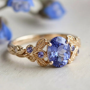 Aria‘s Glade | Oval Cut Tanzanite & Blue Diamond Leaf Engagement Ring.