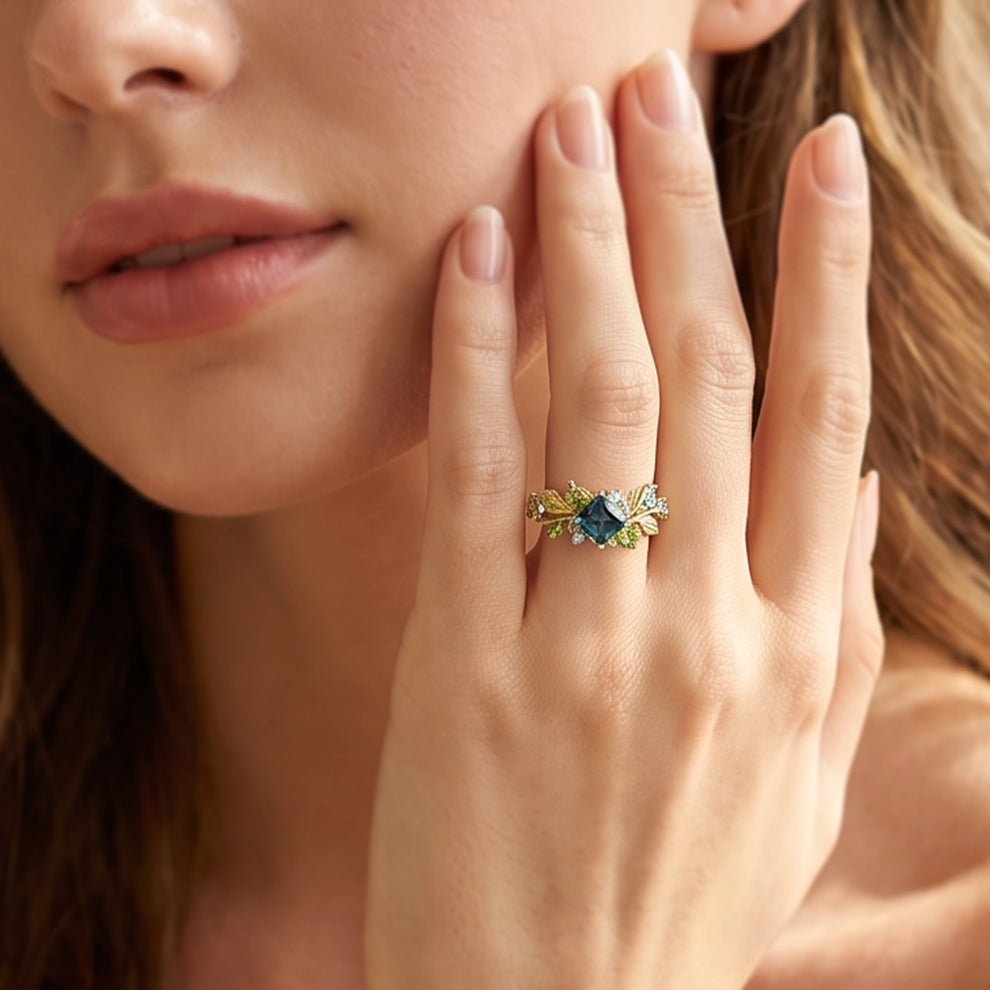 Elowen’s Gildedfrond | Princess Cut London Blue Topaz Leafy Engagement Ring.