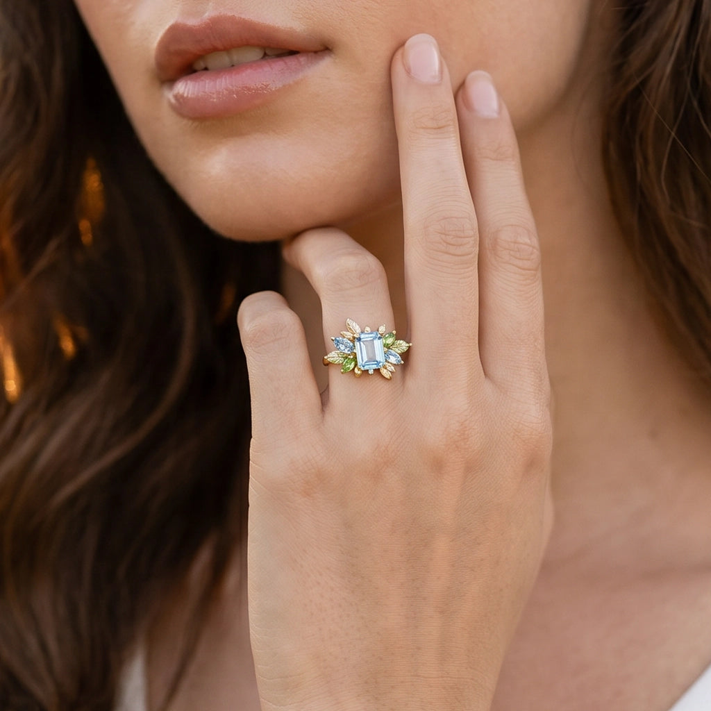 Flora’s Spring | Emerald Cut Blue Aquamarine Leaf Halo Engagement Ring.