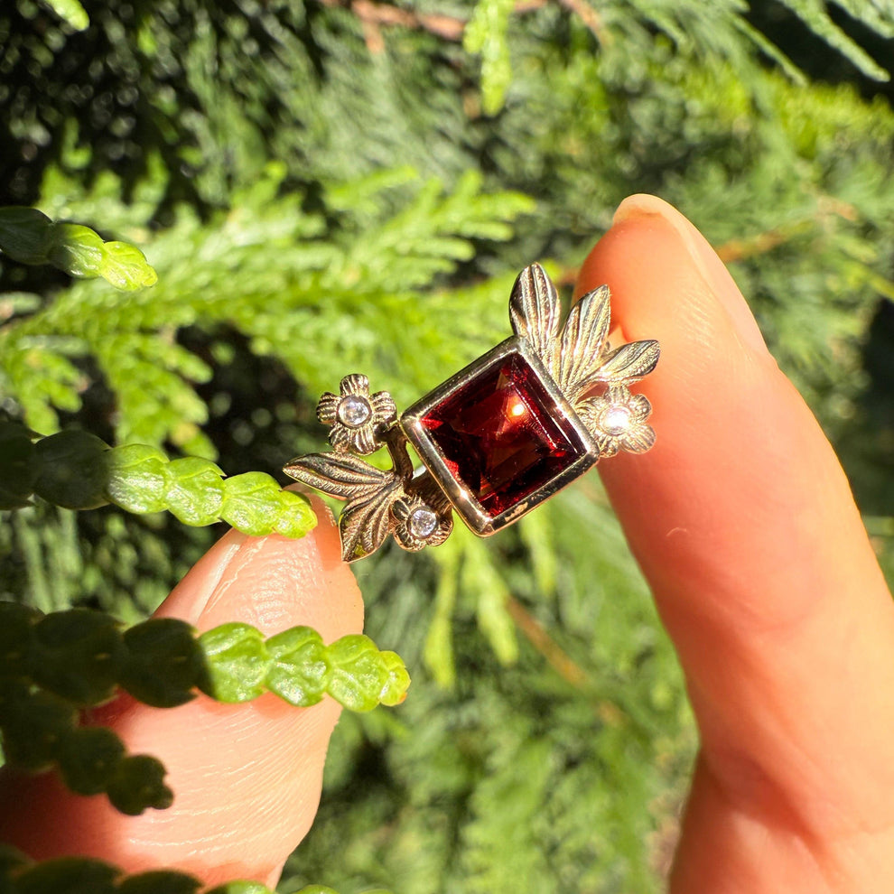 Juliet’s Crimson | Classic Princess Cut Red Ruby Leafy Halo Engagement Ring.