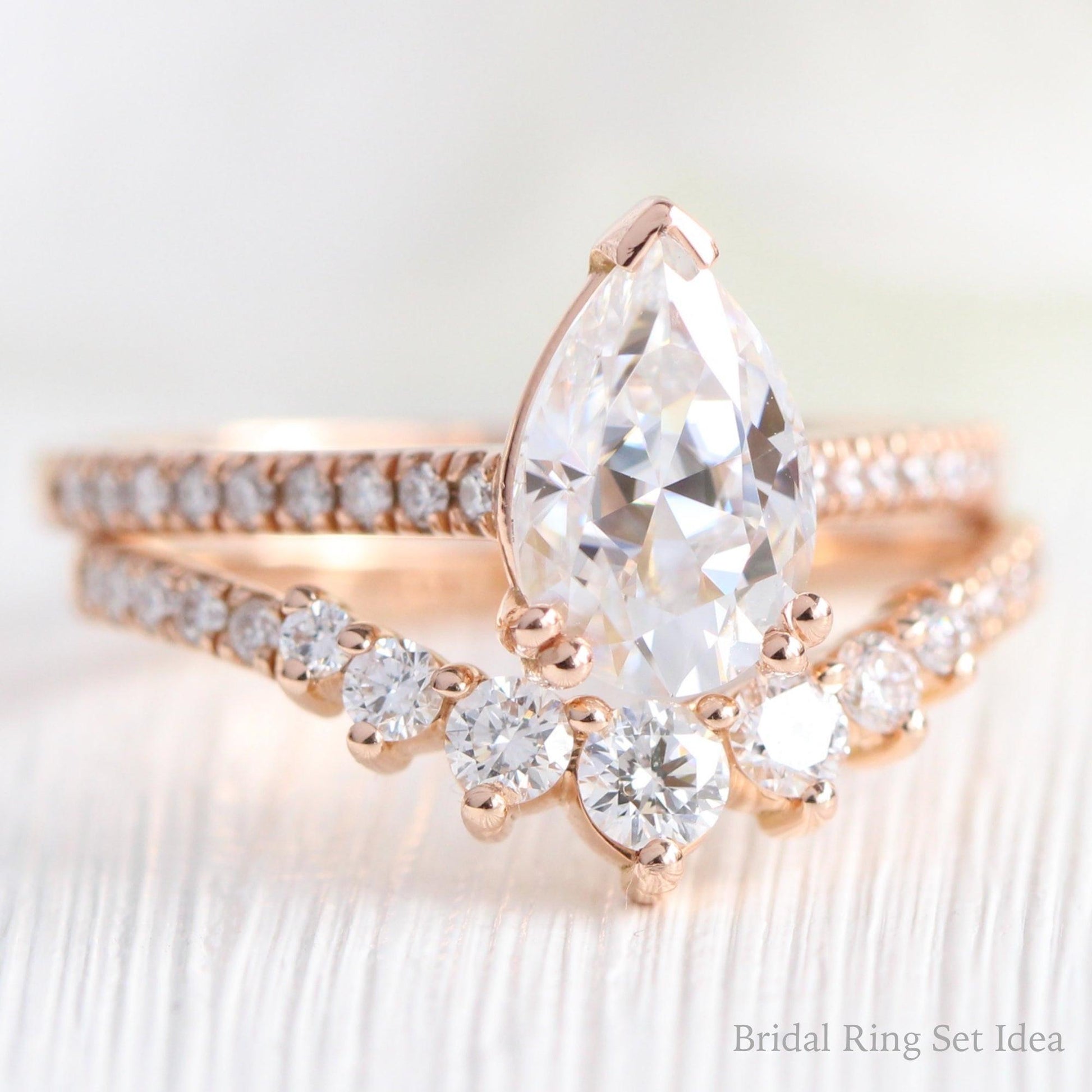 Pear Moissanite Engagement Ring in Grace Solitaire Pave Diamond Band.