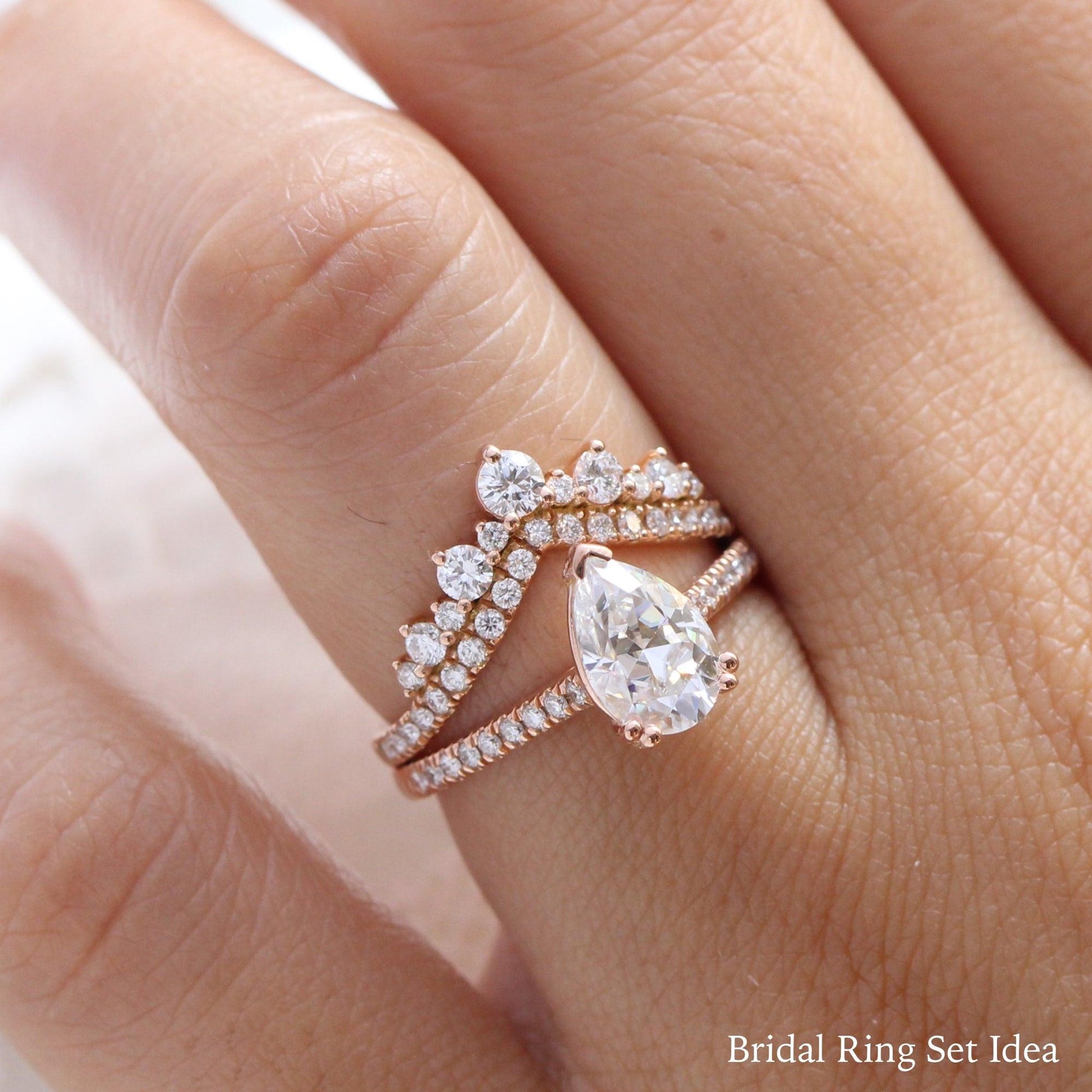 Pear Moissanite Engagement Ring in Grace Solitaire Pave Diamond Band.