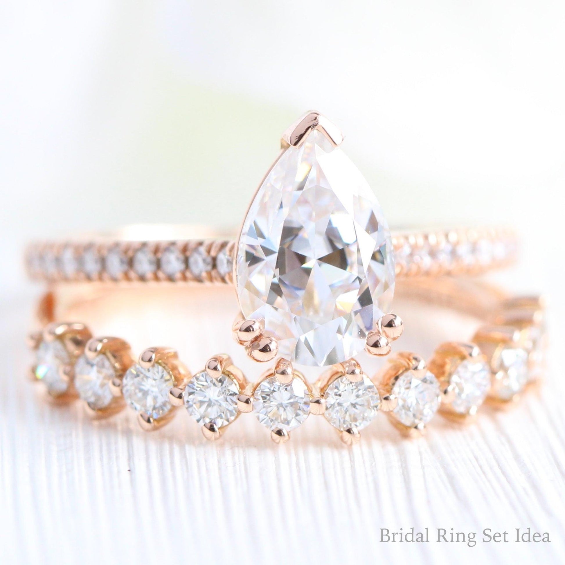 Pear Moissanite Engagement Ring in Grace Solitaire Pave Diamond Band.