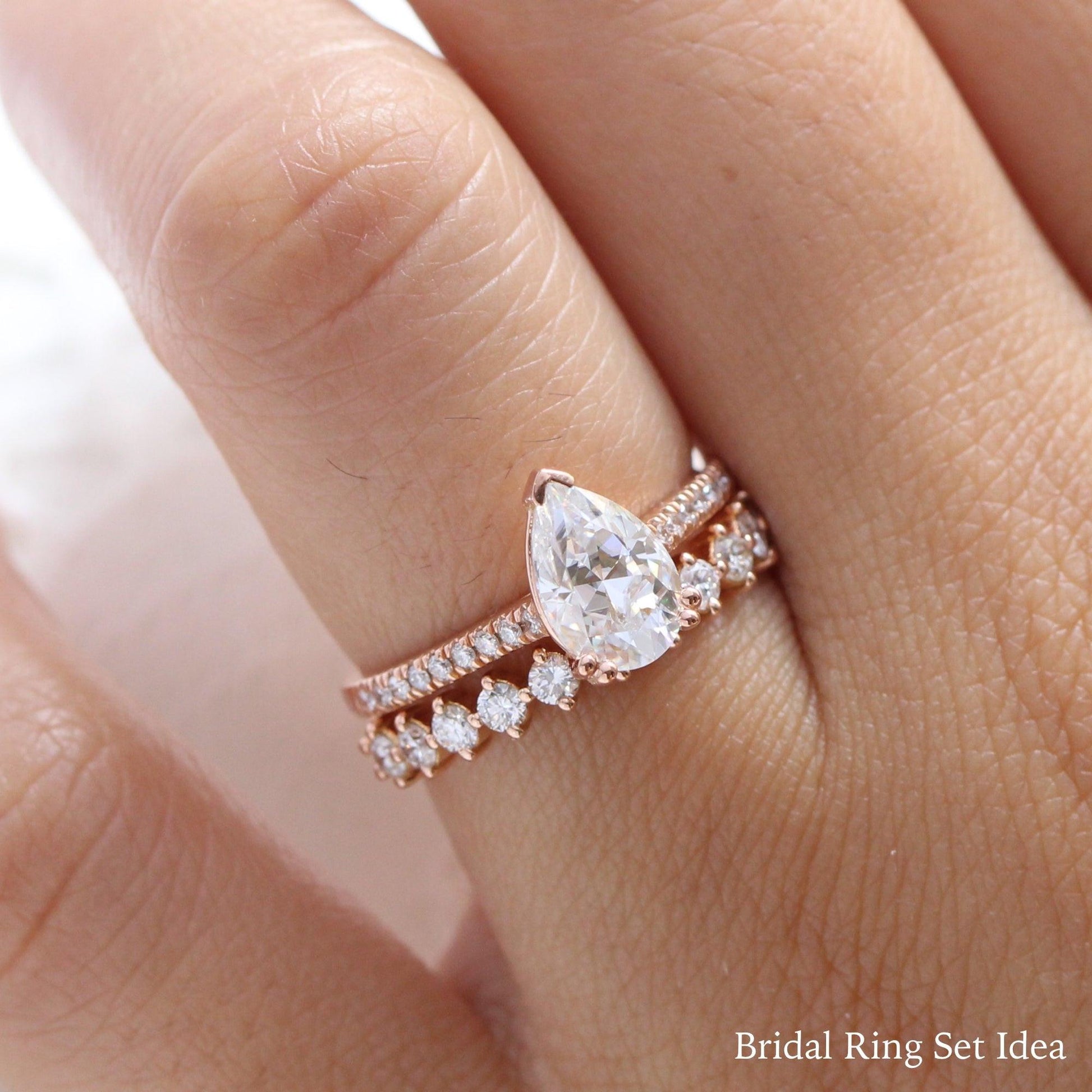 Pear Moissanite Engagement Ring in Grace Solitaire Pave Diamond Band.