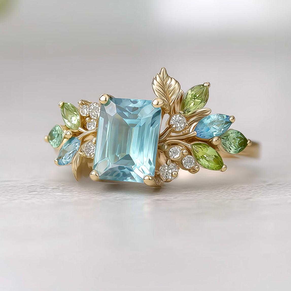Calista’s Bloom | Emerald Cut Aquamarine Engagement Ring with Asymmetric Floral Accents.