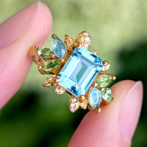 Celeste’s Bloom | Emerald Cut Blue Topaz Leafy Engagement Ring.